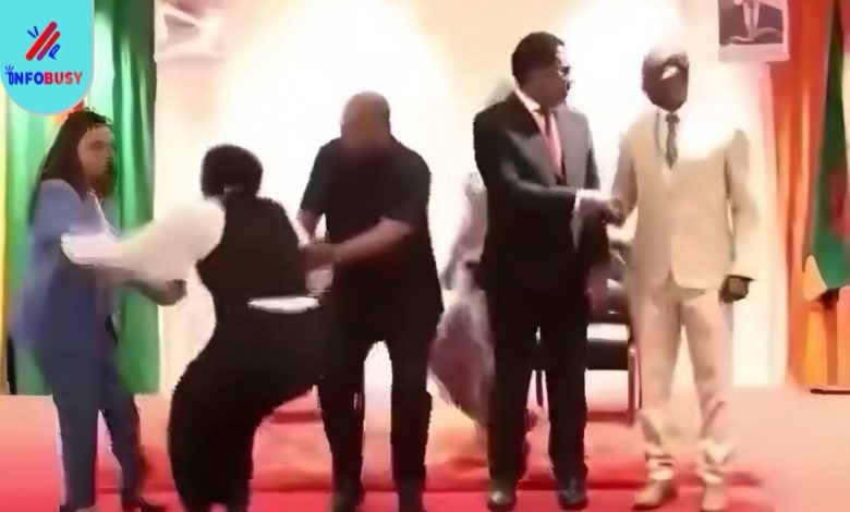 President John Dramani Mahama holding a woman to prevent her from falling on stage during a public event in Zambia