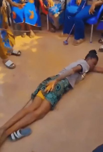 Elderly women publicly flogging a young lady in a Nigerian community